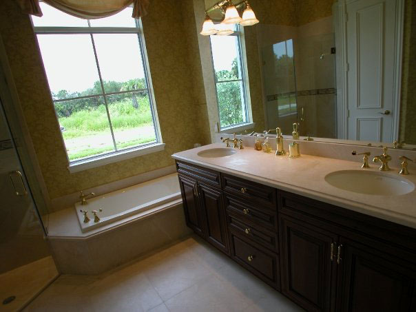 Renovated bright bathroom with natural stone countertop