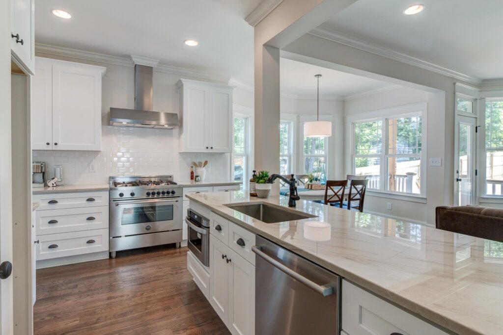 Monochrome kitchen combining pure white quartz countertops and stainless steel kitchen appliances