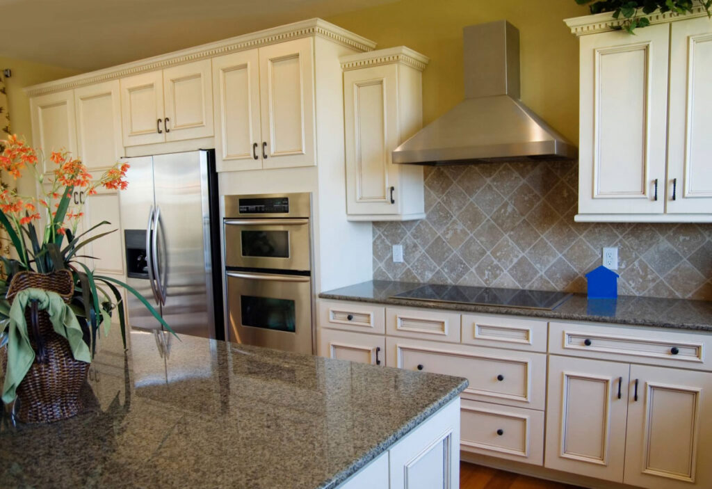 White island kitchen with backsplash to match granite countertop