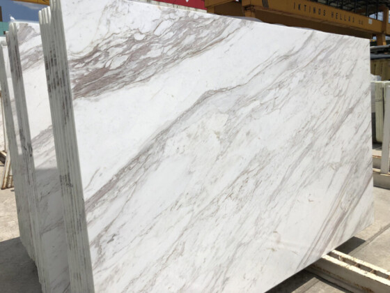 White slab featuring sweeping tan marble veins