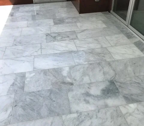 Patio with large white marble floor tiles