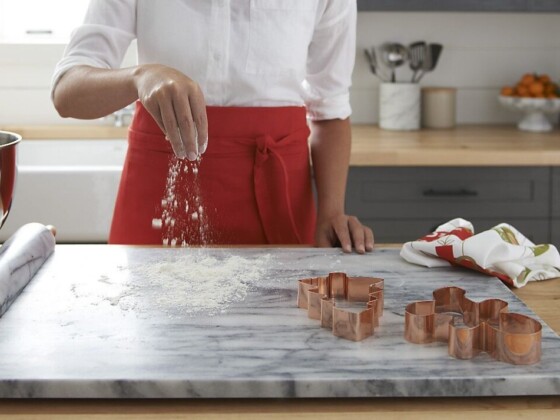 Copper gingerbread cutters on floured marble