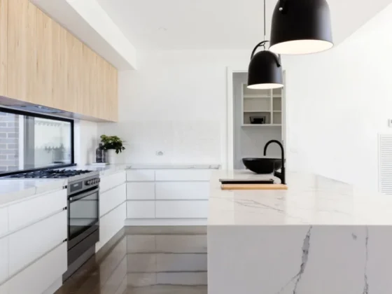 Polished floor reflecting marble island and fixtures