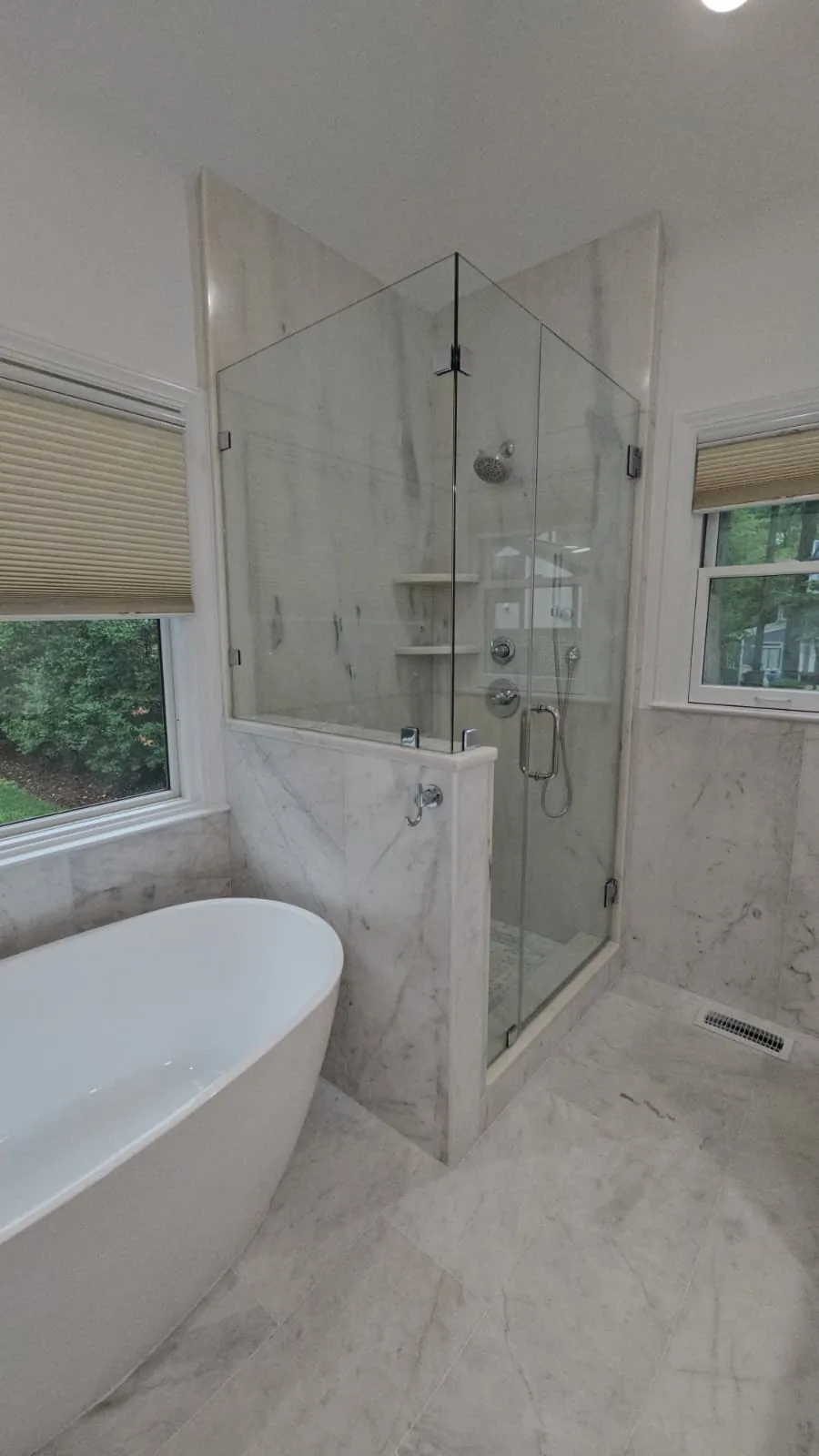 Honed White Carrara floor and polished Carrara wall surfaces