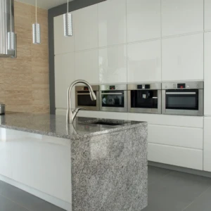 Modern kitchen island with granite countertop and faucet