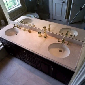 Double sink bathroom vanity with gold faucets