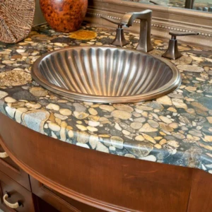 Pebble-patterned stone countertop with fluted sink