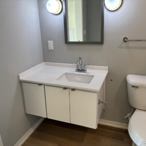 Minimalist bathroom with floating vanity and modern fixtures.