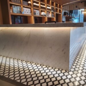 Marble reception desk with patterned tile floor
