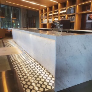 Long marble bar counter with patterned floor