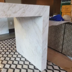 White marble counter leg and patterned tiles