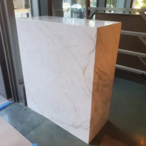 Large white marble block near door
