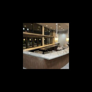 Modern kitchen island with marble countertop and bar stools.
