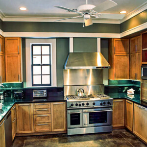 Modern kitchen with wooden cabinets and stainless steel appliances.