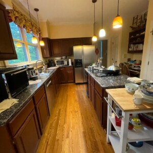 Cozy kitchen with wooden cabinets, hardwood floors, and modern appliances.