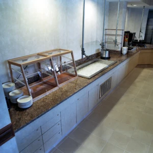 Empty buffet counter with ice and plates