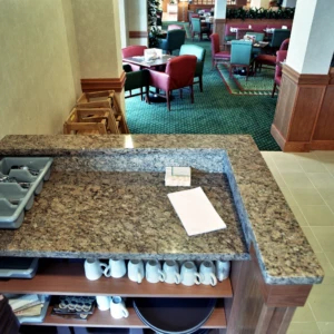 Counter with utensils and mugs in restaurant