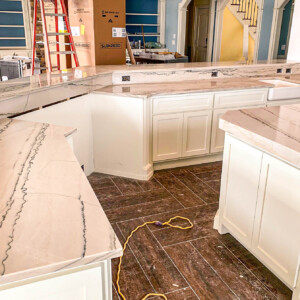 Newly installed marble countertops in a kitchen under construction.