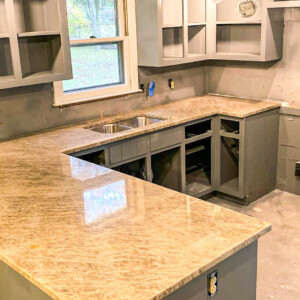 Newly installed granite countertops in a kitchen under renovation.