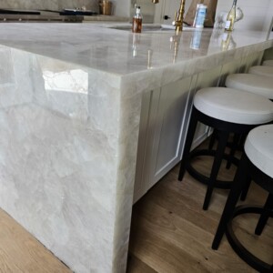 Polished marble kitchen island with bar stools