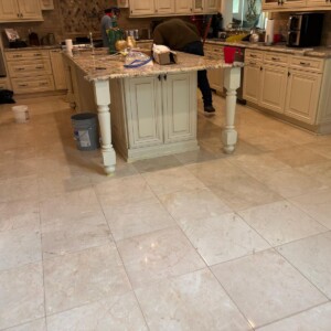 Cream kitchen with island and tiled floor