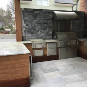 Outdoor stainless steel grill and marble countertops