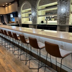 Long marble bar with row of stools