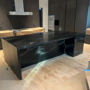Large veined black stone island countertop