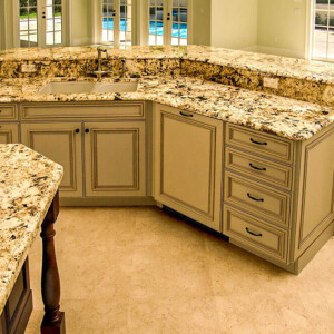 Elegant kitchen with granite countertops and beige cabinetry.