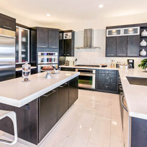 Beautiful Modern kitchen with a counter height barArchitecture: Modern kitchen with dark cabinetry and white countertops.